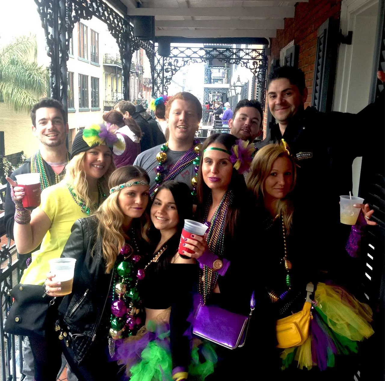 Guests celebrating together on a Bourbon Street balcony
