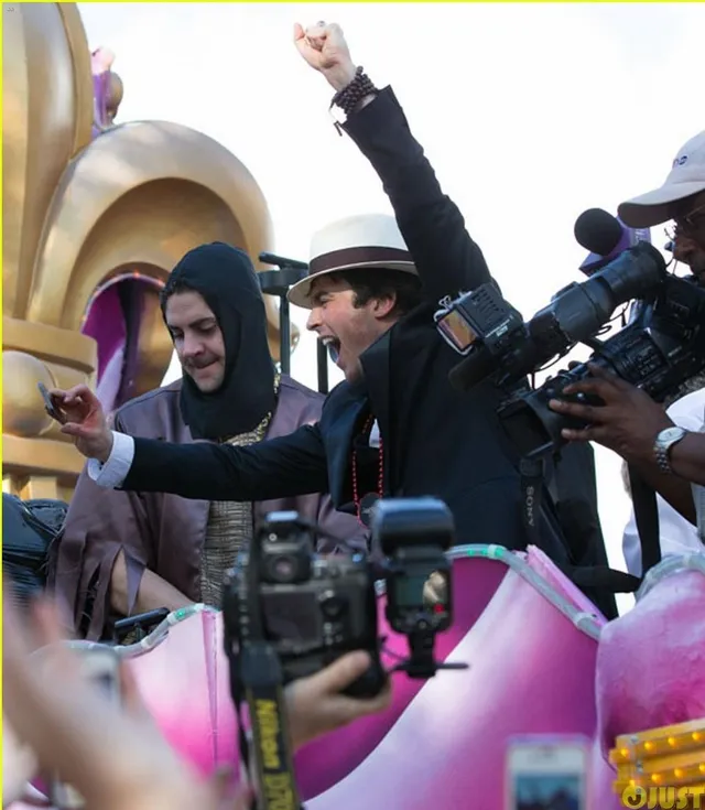 Riders waving from a decorated Mardi Gras float