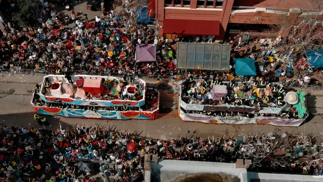 An overhead view of a parade float and crowds lining the street