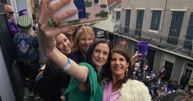 Guests taking a selfie above a crowded street
